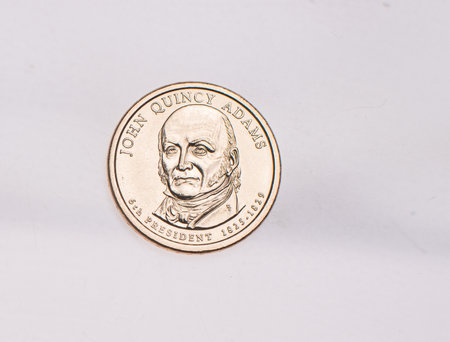 The four most commonly used American Coins. A quarter, dime, nickle, and penny isolated on a white backgroundの写真素材