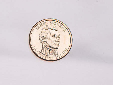 The four most commonly used American Coins. A quarter, dime, nickle, and penny isolated on a white backgroundの写真素材