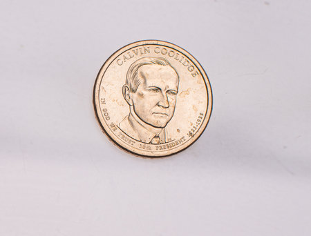 The four most commonly used American Coins. A quarter, dime, nickle, and penny isolated on a white backgroundの写真素材