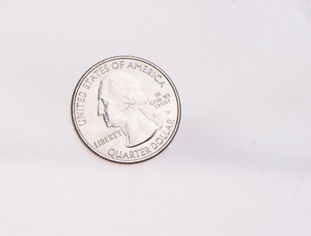 The four most commonly used American Coins. A quarter, dime, nickle, and penny isolated on a white backgroundの写真素材