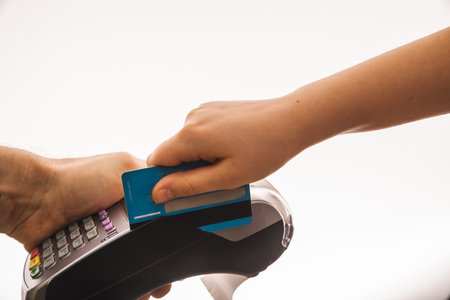 Customer using credit card for payment to owner at cafe restaurant, cashless technology and credit card payment conceptの写真素材