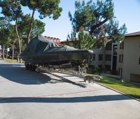 power boat parked covered white protective plastic film New boats in cover casing shrink wrap on sailboat stored for winterの写真素材