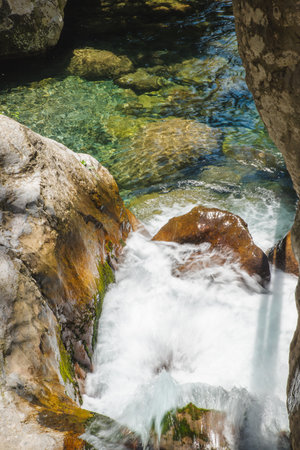 Female slackliner walking a highline over a waterfallの写真素材