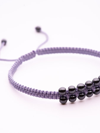Black hematite handmade bracelet on white backgroundの写真素材