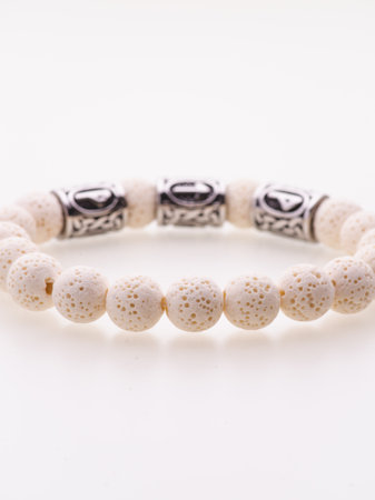 A charming double bracelet in shades of pink, made from natural stone. The heart charm with cubic zirconia stands out in this close-up top viewの写真素材