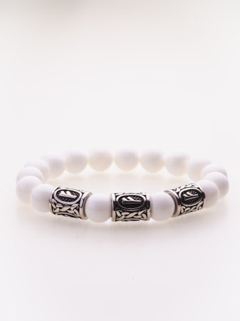 A charming double bracelet in shades of white, made from natural stone and set against a white background. The close-up view highlights the intricate design and craftsmanship of the piece.の写真素材