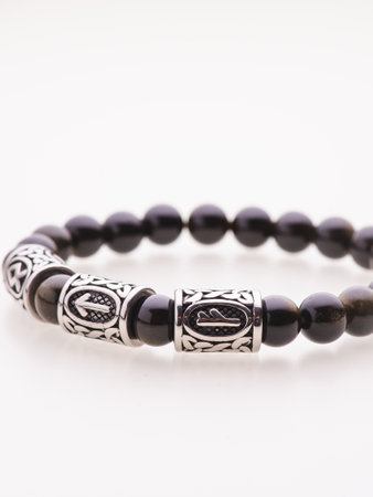 A charming double bracelet in shades of pink, made from natural stone. The heart charm with cubic zirconia stands out in this close-up top viewの写真素材