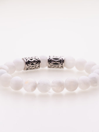 A charming double bracelet in shades of pink, made from natural stone. The heart charm with cubic zirconia stands out in this close-up top viewの写真素材