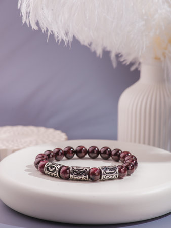 Woman's wrist wearing orange agate bracelet, isolated on white background.の写真素材