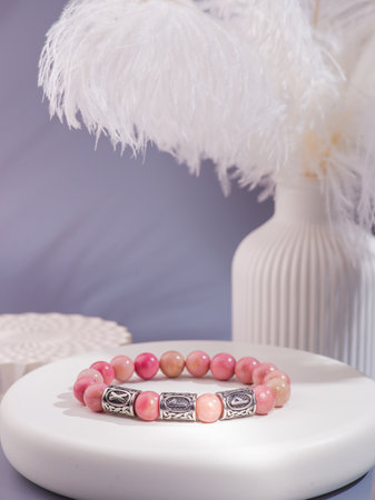 Pink and peach beaded bracelet with silver accents, displayed on a white background.の写真素材