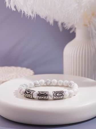 Woman's wrist wearing orange agate bracelet, isolated on white background.の写真素材