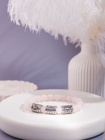 Woman's wrist wearing agate bracelet, isolated on white background.の写真素材
