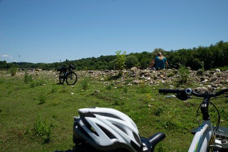 Cyclists resting on a hillside in the summertime.の写真素材
