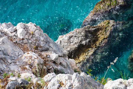 Stunning view of pristine coastline featuring traditional whitewashed Mediterranean architecture,...