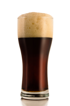 Dark beer in a glass, isolated on a white background.の写真素材