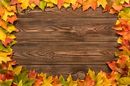 fallen leaves on wooden background, top view, copy space