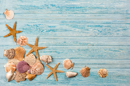 Summer sea background - shells, star on a wooden blue backgroundの写真素材