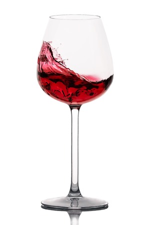 moving red wine glass over a white backgroundの写真素材