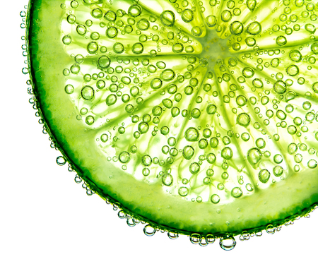 lime with bubbles in water isolated on white background.の写真素材