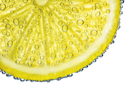 lemon with bubbles in water isolated on white backgroundの写真素材