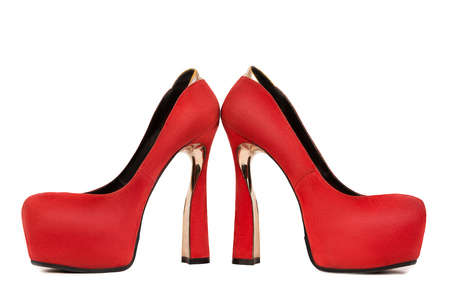 Woman red shoe on white background. Red female shoe on high heel on white background in profile. Woman fashion accessoryの写真素材