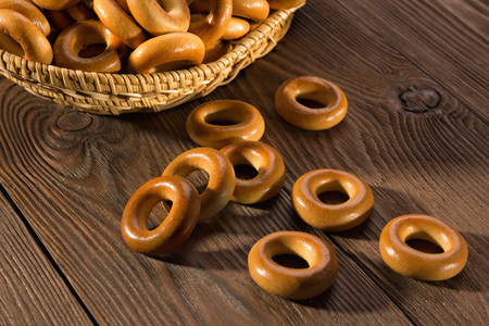 Small dry bagels on wooden table, top view.の写真素材