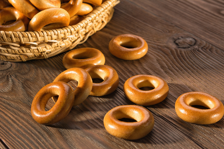 Small dry bagels on wooden table, top view.の写真素材