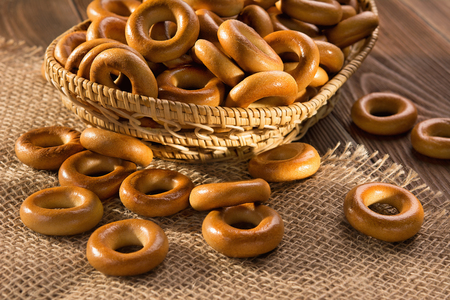 Small dry bagels on wooden table, top view.の写真素材
