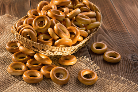 Small dry bagels on wooden table, top view.の写真素材