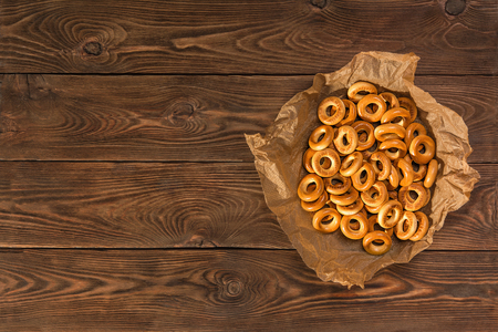 Small dry bagels on a wooden table, view from the side.の写真素材