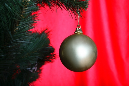 Christmas tree with ball against red backgroundの写真素材