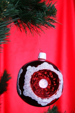 christmas ball in fir against red backgroundの写真素材
