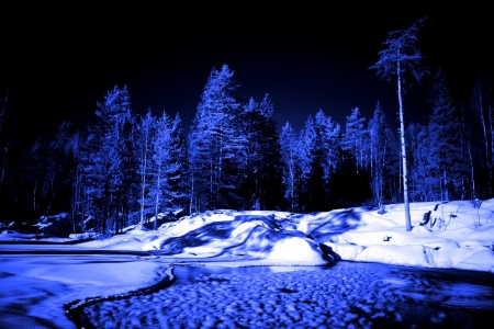 moon night in winter forest and lake with ice ballの写真素材