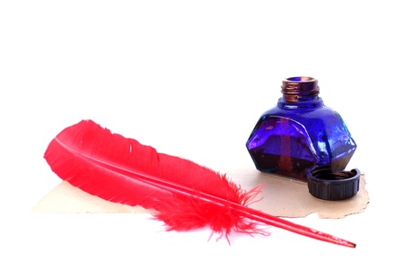 Antique red pen and inkwell at old paper isolated on whiteの写真素材