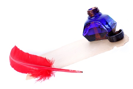 Antique red pen and inkwell at old paper isolated on whiteの写真素材