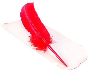 Antique red pen at old paper isolated on whiteの写真素材