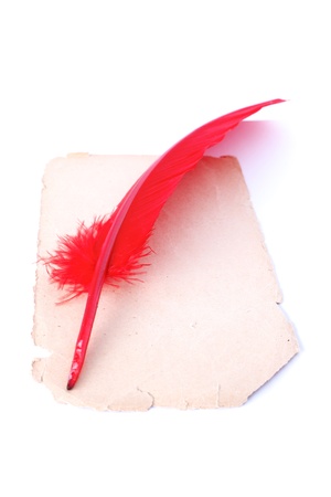 Antique red pen at old paper isolated on whiteの写真素材