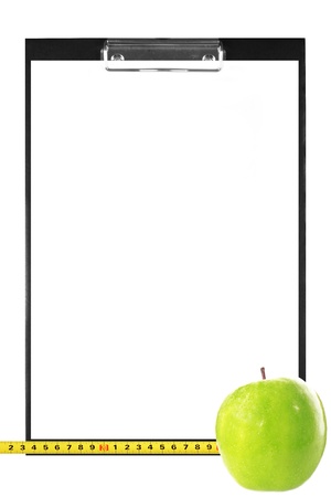 diet or learning plan - blank clipboard with a measuring tape, apple isolated on whiteの写真素材