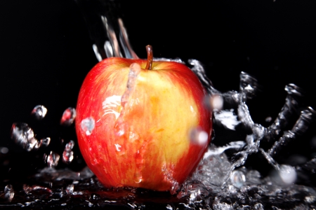 fresh red-yellow apple in water splashの写真素材