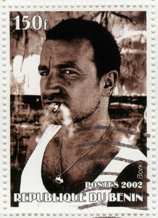 BENIN - CIRCA 2002 : Stamp printed in Benin shows Bono - frontman U2 rock band, circa 2002のeditorial素材