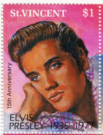 ST. VINCENT - CIRCA 1992 : stamp printed in St.Vincent - famous rock and roll singer and actor Elvis Presley, circa 1992のeditorial素材