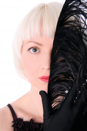 lovely woman hiding face of black feather isolated on white