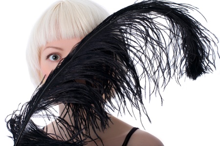 lovely woman hiding face of black feather isolated on white