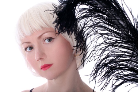 lovely woman with black feather isolated on whiteの写真素材