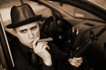 man in car with cigar and rifleの写真素材