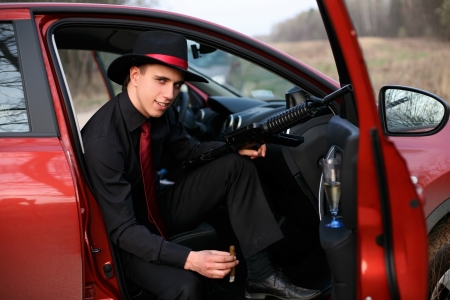 man in car with cigar and rifleの写真素材