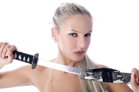 lovely woman holding in her hands a katana isolated on whiteの写真素材