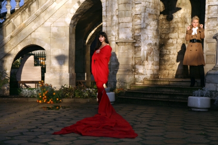 lovely woman beside old castle in red fabricの写真素材