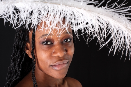 afro-american woman with white feather against black backgroundの写真素材