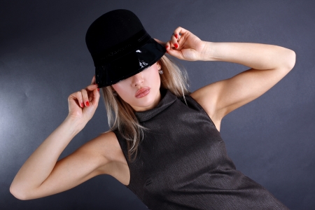 fashion young woman in hat hiding eyeの写真素材